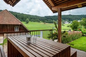 a wooden table on a balcony with two glasses on it at Ferienhaus Kornspeicher in Hornberg