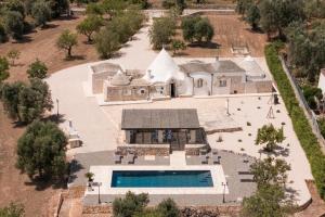 an aerial view of a house with a swimming pool at Trulli Aletheia Con Piscina Privata in Ceglie Messapica +16 photos
