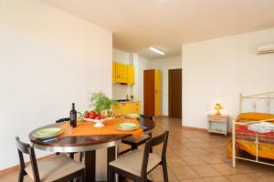 a kitchen and dining room with a table and chairs at Monolocale nel centro di Racale in Racale