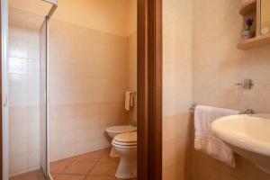 a bathroom with a toilet and a sink at Monolocale nel centro di Racale in Racale