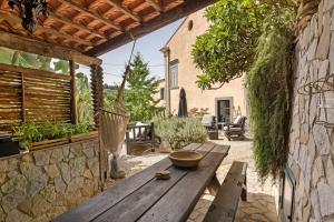 a wooden picnic table in the courtyard of a house at Villa Cangiani in Massa Lubrense
