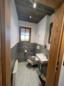 a bathroom with a toilet and a sink at Ferienwohnung Wiagsog in Garmisch-Partenkirchen +11 photos