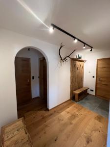 a room with two doors and a wooden floor at Ferienwohnung Wiagsog in Garmisch-Partenkirchen