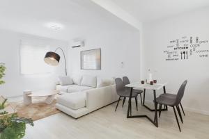 a living room with a white couch and a table at Casa Pablo City Center in Fuengirola