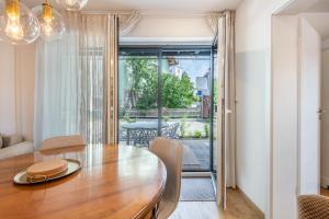 a dining room with a table and a view of a patio at bei Thérèse - Erdgeschoss in Miltach