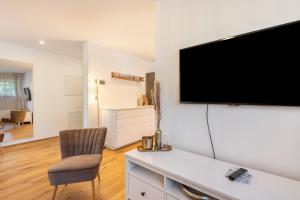 a living room with a flat screen tv on a wall at bei Thérèse - Erdgeschoss in Miltach