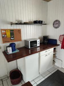 a kitchen with a counter with a microwave on it at Ferienunterkunft Göhlich in Maintal +2 photos