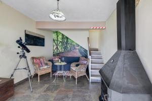 a living room with a camera and a staircase at Vv Terrazita in Tijarafe