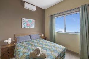 a bedroom with a bed and a large window at Vv Terrazita in Tijarafe +20 photos