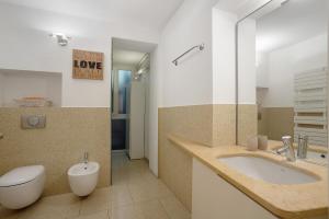 a bathroom with a toilet and a sink and a toilet at Crocetta10 in Milan +12 photos