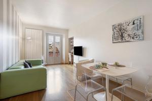 a living room with a table and a green couch at Crocetta10 in Milan