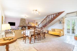 a living room with a dining room table and a staircase at Ilios Country house in Arillas