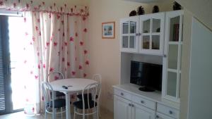 a living room with a tv and a table and a cabinet at Playa de las Americas Cool Duplex in Playa de las Americas