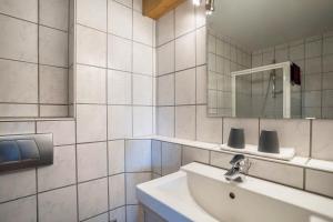 a white bathroom with a sink and a mirror at Ferienwohnung Ohnemus in Schuttertal +20 photos