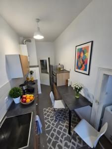 a kitchen and dining room with a table and chairs at Max Hinterhaus in Dresden