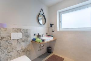 a bathroom with a sink and a mirror at Luisalle Top 3 in Auffach +15 photos