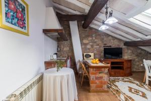 a living room with a table and a tv at Casa Velarde Apto 1 in Viérnoles