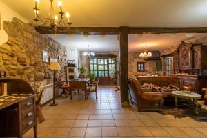 a living room with a couch and a stone wall at Casa Velarde Apto 1 in Viérnoles
