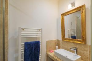 a bathroom with a sink and a mirror at Studio De Caractère Classé 3 in Les Vans