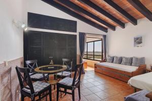 a living room with a couch and a table and chairs at Pedras Del Rei 26 in São Pedro