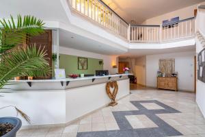 a lobby with a reception counter and a staircase at Fewo Brünnstein - Nr 46 Pool, Sauna in Oberaudorf +25 photos
