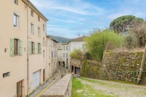 an alley in an old town with buildings at Studio De Caractère Classé 3 in Les Vans