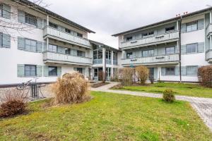 an apartment building with a lawn in front of it at Fewo Brünnstein - Nr 46 Pool, Sauna in Oberaudorf