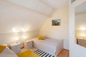 a small bedroom with a bed and two night stands at Nordseezeit Strandnah u Poolrabatt in Butjadingen