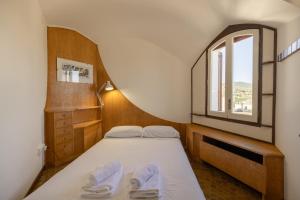 a small bedroom with a bed and a window at Villa La Guaita in Ríudecañas +31 photos