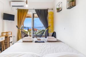 a bedroom with a bed and a window at Oceanida Aelia room in Nikiana +20 photos