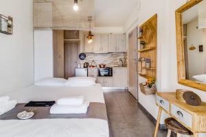 a small room with two beds and a kitchen at Oceanida Aelia room in Nikiana
