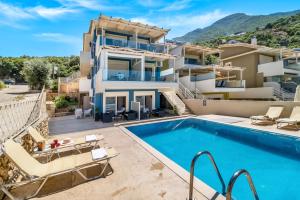 an image of a villa with a swimming pool at Oceanida Aelia room in Nikiana