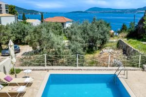 a villa with a pool and a view at Oceanida Aelia room in Nikiana