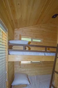 two bunk beds in a wooden cabin at Lake of the Springs Camping Resort Cottage 1 in Oregon House