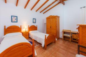 a bedroom with two beds and a desk at S'alqueria Vell in Campanet +27 photos