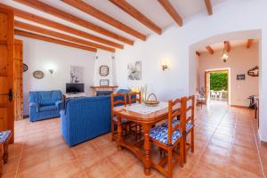 a living room with a table and chairs at S'alqueria Vell in Campanet