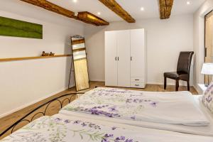 a bedroom with a bed and a chair at Schmid am See in Gaienhofen