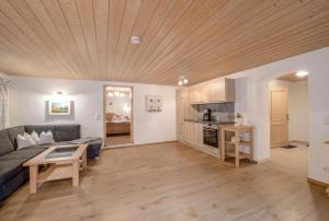 a living room with a couch and a table at Ferienwohnung Waxenstein in Grainau +17 photos