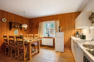 a kitchen and dining room with a table and chairs at Idyllisches Bauernhaus in Gerswalde