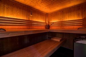 an empty sauna with a bench in the middle at Waldhotel Fletschhorn Private Whole Hotel in Saas-Fee 360 Alpine Views & Sauna in Saas-Fee +142 photos