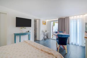 a bedroom with a bed and a desk and a television at La casa di Susy in Avola