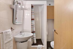 a bathroom with a sink and a toilet at Casa Enxame in Armação de Pêra +17 photos