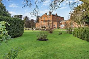 a large brick house with a green yard at 3 Bed in Southwell oc-s30603 in Southwell