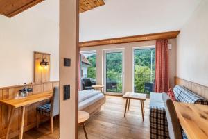 a living room with a couch and a table at Wein- und Klimahotel Bergfriedel in Bühlertal