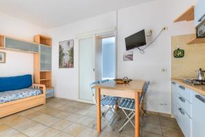 a small kitchen with a table and a desk in a room at Appartamento 3b in Campo nell'Elba +12 photos