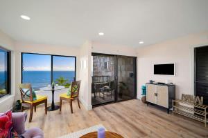 a living room with a view of the ocean at Sealodge A2 Romantic Ocean View Oasis with Pool in Princeville +33 photos