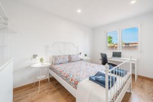 a white bedroom with a bed and a desk at Villa Sueños in Marratxí  +19 photos