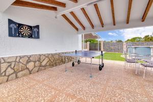 a ping pong table on a patio with a dartboard at Violeta Grande in Macastre