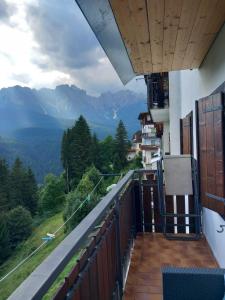 a balcony of a house with a view of mountains at Affittacamere da Annarè in Comèlico Superiore