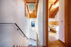 a room with a staircase leading to a bedroom at Thusnelda Apartment C in Siusi